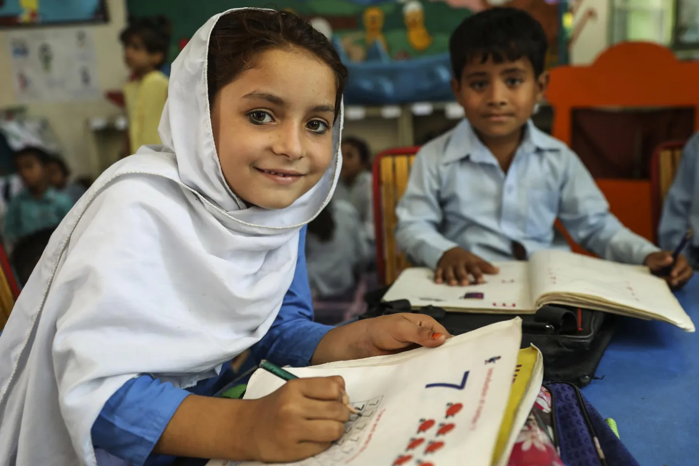 Kanhaiya Krichan and Muskan Ishaq attend their Early Childhood class (ECE) in Government Community Model Elementary School, Dari Ali Akber Sanghi, Rahim Yar Khan district, Punjab province, Pakistan.